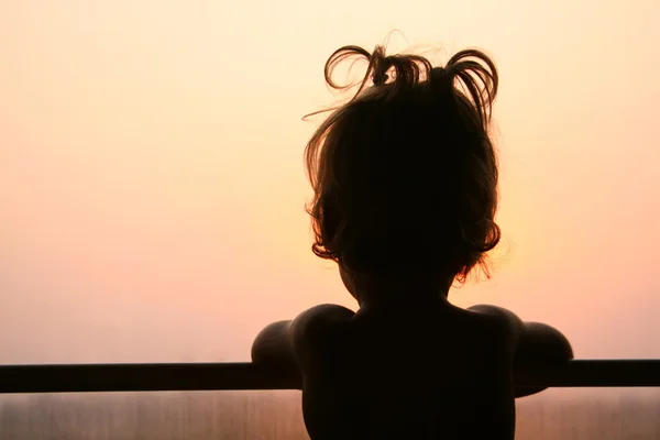 Silhouette of child in window of train — Stock Photo, Image