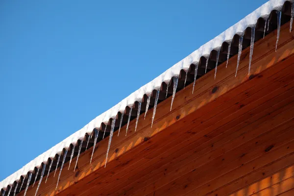 stock image Roof of house with icicles