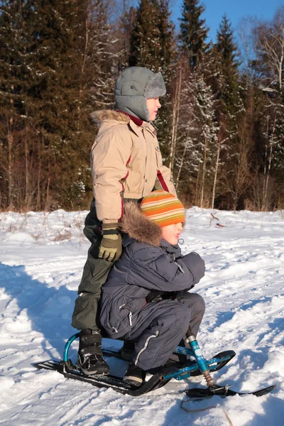 Two boys with snow scooter — Stock Photo, Image