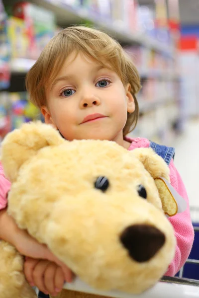 Girl with soft toy in shop — Stock Photo, Image