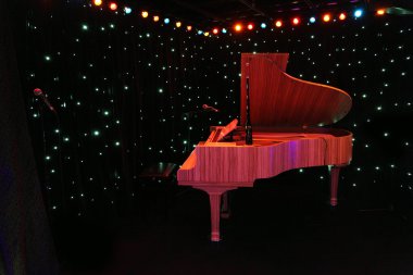 Grand piano at concert stage with black curtain decored multicol clipart