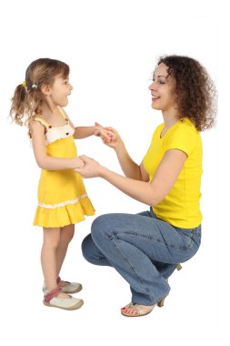 Mother sitting behind the daughter and holding her hands, lookin clipart