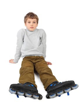 Little roller boy sitting and looking at camera isolated on whit clipart