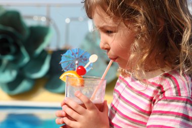 Little girl in shirt with pink stripes drinking cocktail with fr clipart