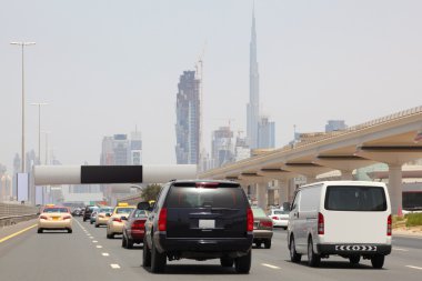 DUBAI - APRIL 18: general view on trunk road with many cars, sky clipart