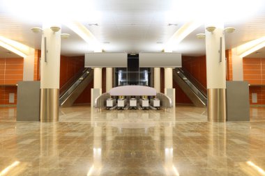 Big modern hall with granite floor, columns and two escalators i clipart