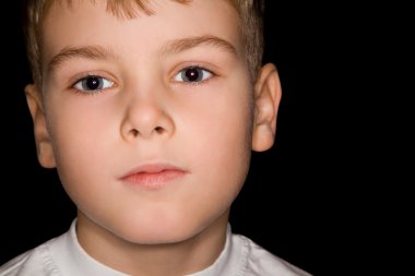 Boy in white T-shirt isolated on black background clipart