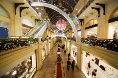 Modern shopping center interior at night. Big floor spaces, esca clipart