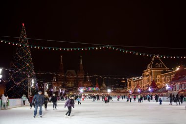 Skating-rink on red square in moscow at night. GUM trading house clipart