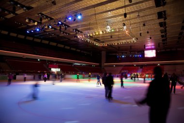 Big covered skating rink with multi-coloured illumination in spo clipart