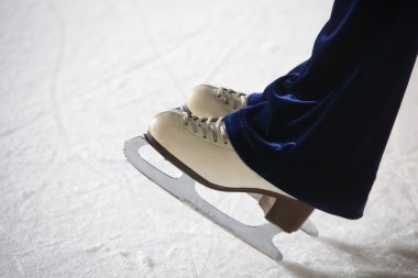 Human feet in fads standing on ice on the brink of an edge on sk clipart