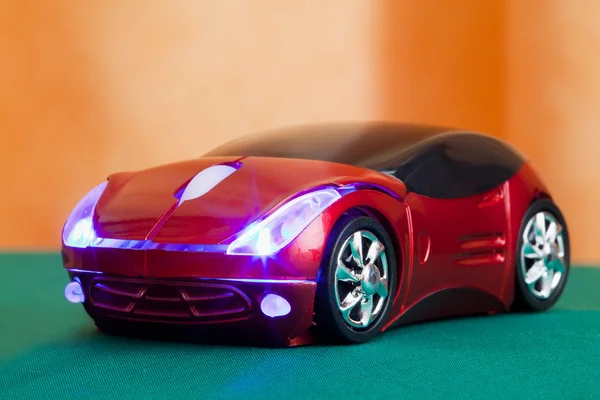 Computer mouse in form toy red sports car with glow headlights — Stock Photo, Image