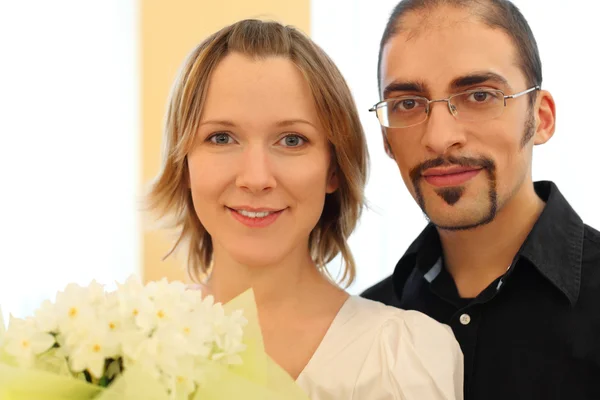 Gözlük ve güzellik sarışın kız ile erkek portresi bo çiçekler — Stok fotoğraf
