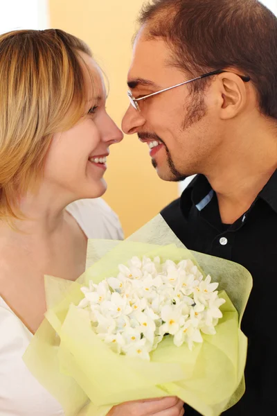 Portrait of man in glasses and beauty blond girl with flowers bo — Stock Photo, Image