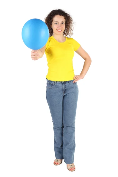 Young attractive woman in yellow shirt and jeans offers blue bal — Stock Photo, Image