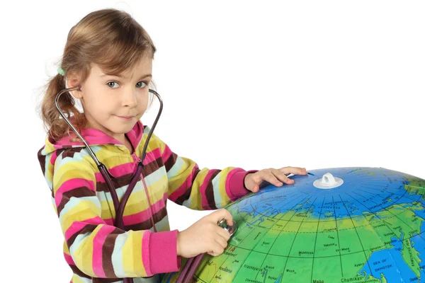 Menina com estetoscópio e grande globo inflável, olhando um — Fotografia de Stock