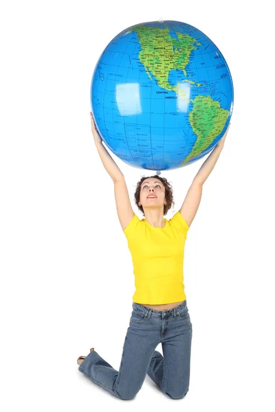 Young woman in yellow shirt sitting and holding big globe, isola — Stock Photo, Image