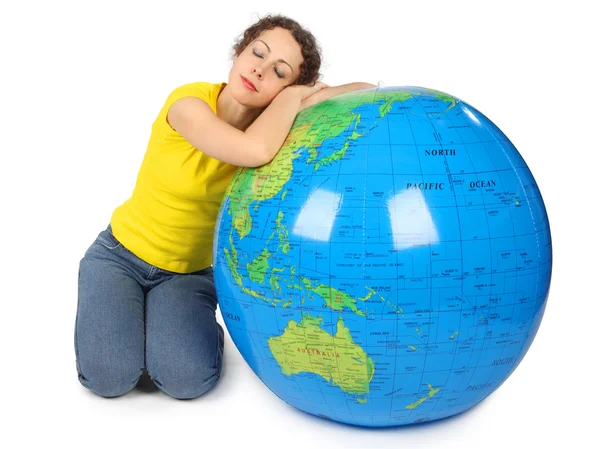 Young beauty woman sitting near big inflatable globe with closed — Stock Photo, Image