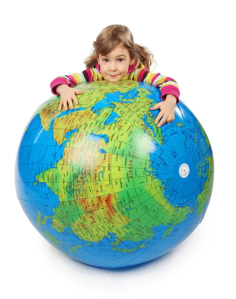 Little girl look out of big inflatable globe and embracing it, i — Stock Photo, Image
