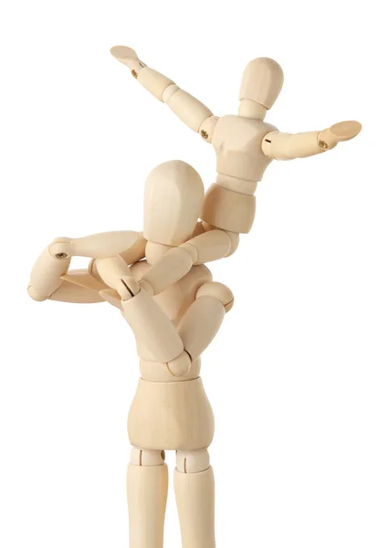 Wooden figures of child sitting on neck of his parent and puttin — Stock Photo, Image