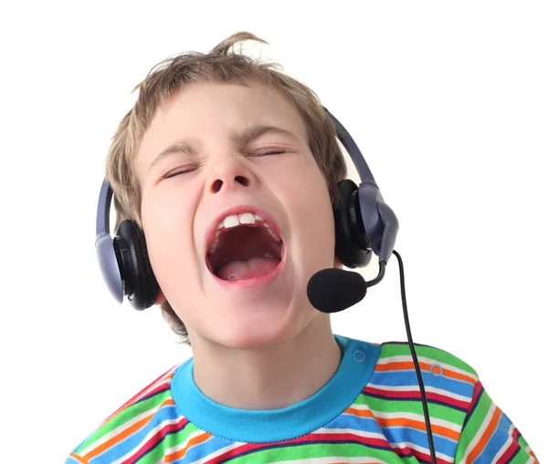 Portrait of little boy with headphones and microphone singing wi — Stock Photo, Image