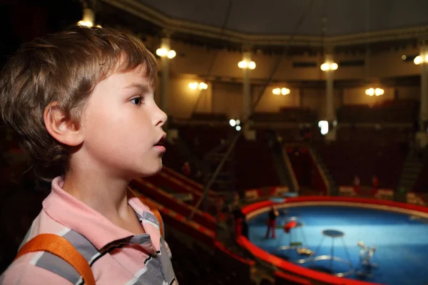 Profile of little boy in circus with blue arena looking at side — Stock Photo, Image