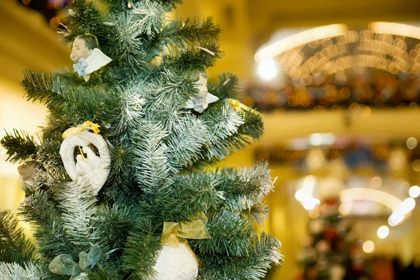 Christmas ornament in form of pigeons on fur-tree in shopping ce — Stock Photo, Image