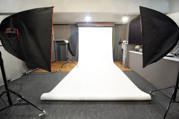 Interior of professional photo studio with white background — Stock Photo, Image