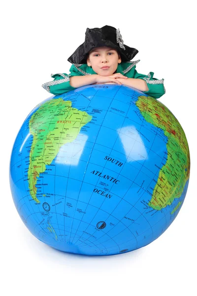 Boy in historical dress leans on inflatable globe chin on hands — Stock Photo, Image