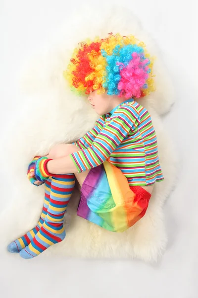 Boy in clown dress sleeping view frome above on white background — Stock Photo, Image