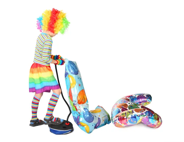 Boy in clown dress pupming birthday balloons isolated on white b — Stock Photo, Image