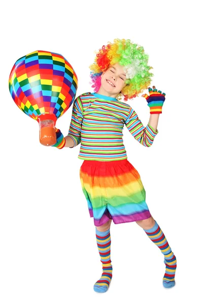 Boy in clown dress with multicolored hot-air balloon standing is — Stock Photo, Image