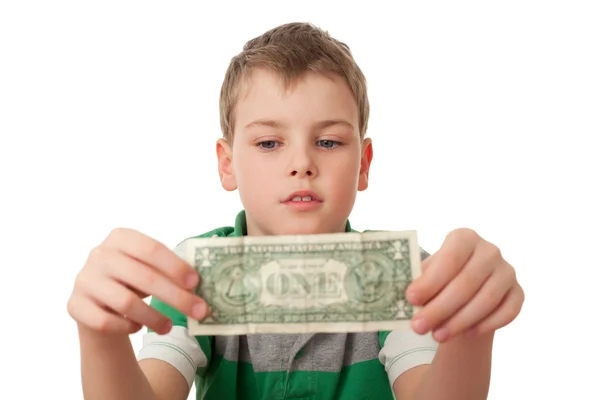 Jongen houdt een dollar in beide handen geïsoleerd op witte achtergrond — Stockfoto