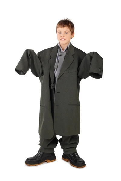 Little boy in big grey man's suit and boots standing isolated on — Stock Photo, Image