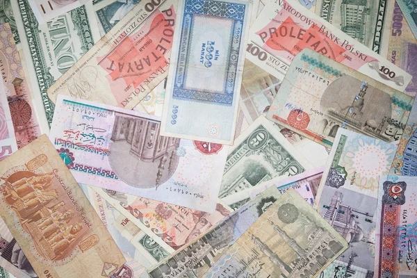 Achtergrond uit bankbiljetten van verschillende monetaire valuta — Stockfoto