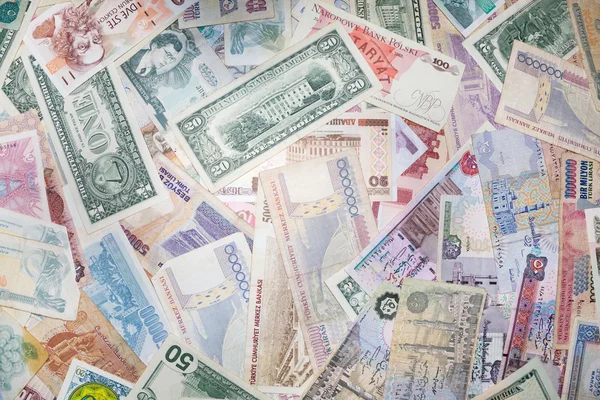Tło z banknotów o różnych monetarnych waluty — Zdjęcie stockowe