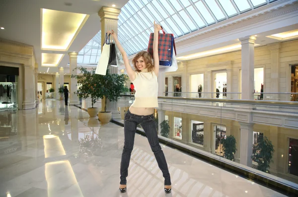 Chica con bolsas en tienda collage — Foto de Stock