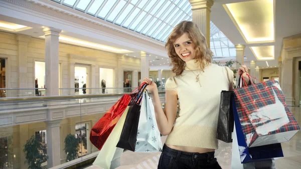 Chica con bolsas en tienda collage — Foto de Stock