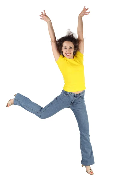 Young attractive woman in yellow shirt and jeans jumping and smi Stock Photo