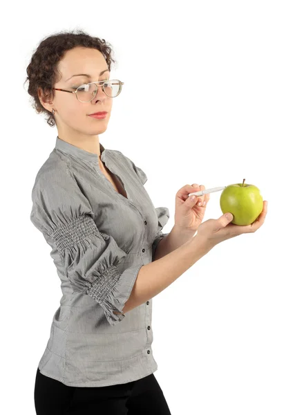 Joven mujer atractiva en vestido de negocios sosteniendo una manzana y po Fotos de stock