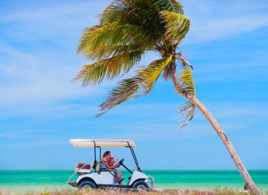 Golf cart at tropical beach clipart