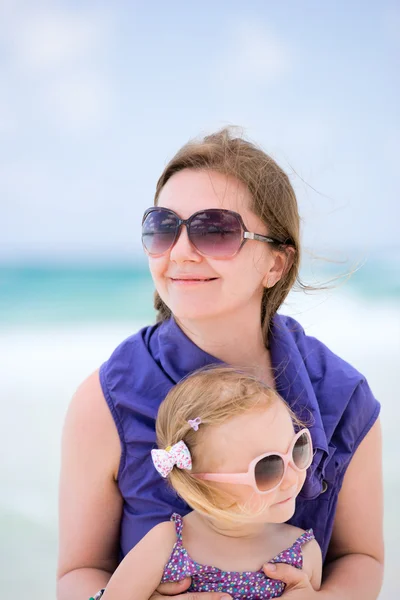 Happy mother and daughter at beach Stock Image