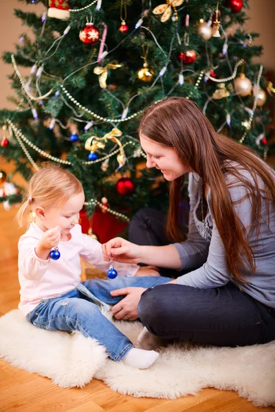 Mother and daughter near Christmas tree — Stock Photo, Image