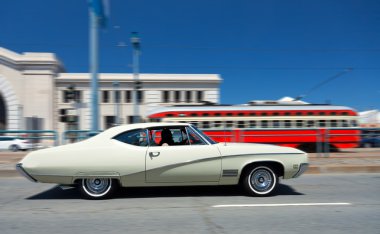 Vintage retro car on city street clipart