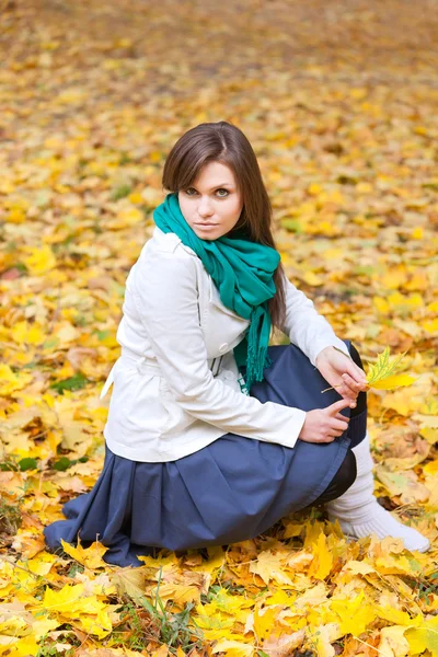 Beautiful woman in white coat and scarf — Stock Photo, Image