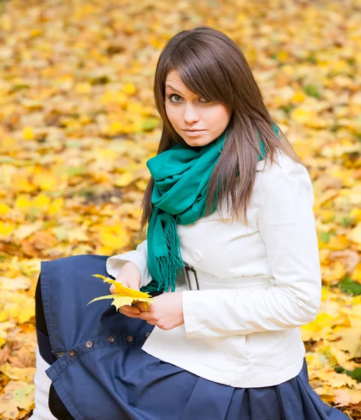 Beautiful woman with yellow leaf — Stock Photo, Image