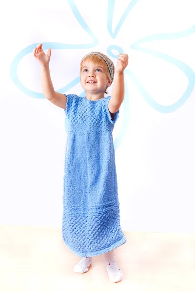 Cheerful little girl in knitted blue dress — Stock Photo, Image