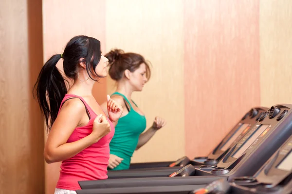 Young women on a running simulator — Stock Photo, Image