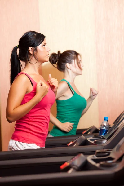 Young women on a running simulator — Stock Photo, Image