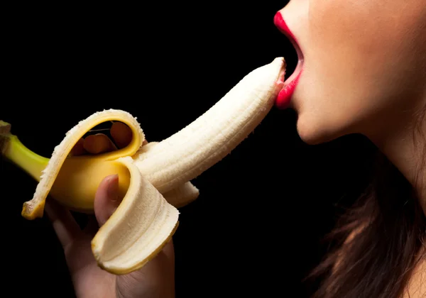 stock image Young woman eating banana